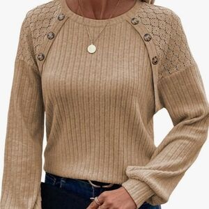 Women's lightweight sweater top with lace shoulders and button detail.